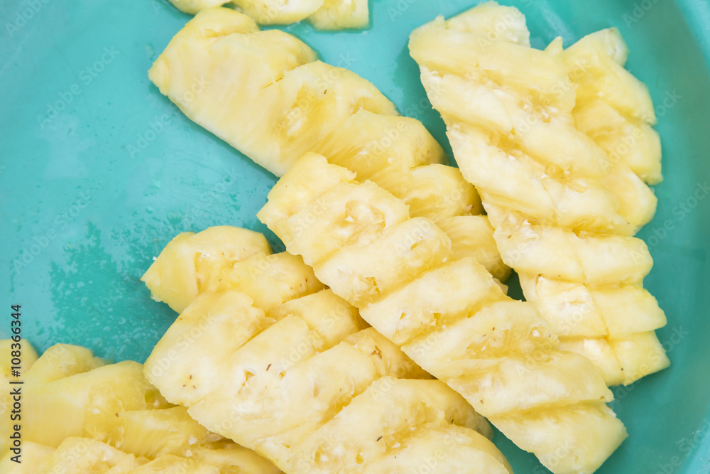 Slice pineapple on green tray copyspace. Slice pineapple on green tray copyspace.