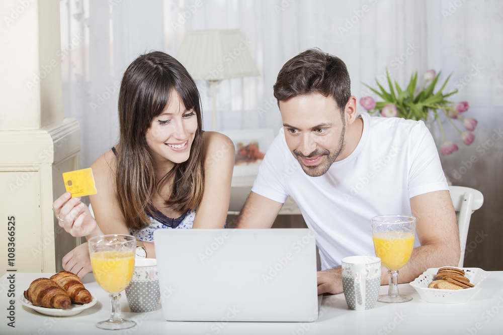 Online Shopping. Happy Smiling Couple Using Credit Card to Internet Shop on-line.