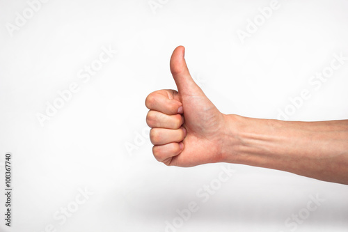 male hand showing thumbs up sign 