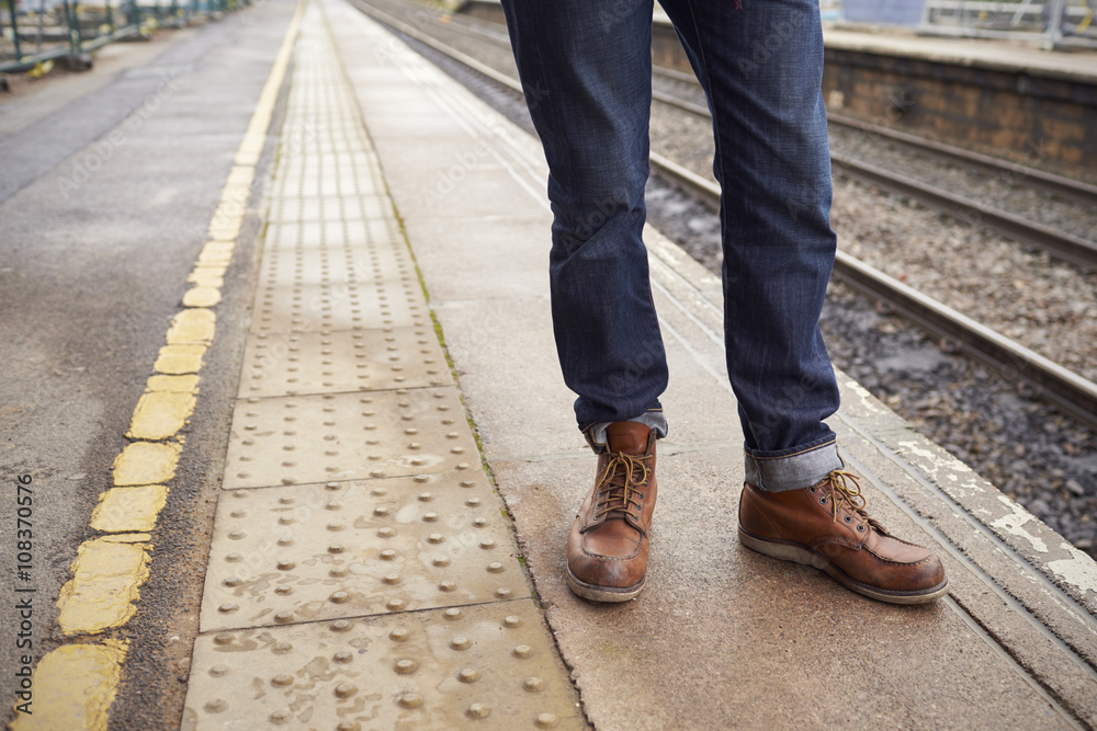 Detail Of Man Standing On Railway Platform Waiting For Train Detail Of Man Standing On Railway Platform Waiting For Train