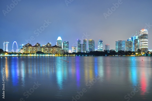 Greenery by Kallang River  south of Singapore   with downtown skyline and colourful reflections in the background..
