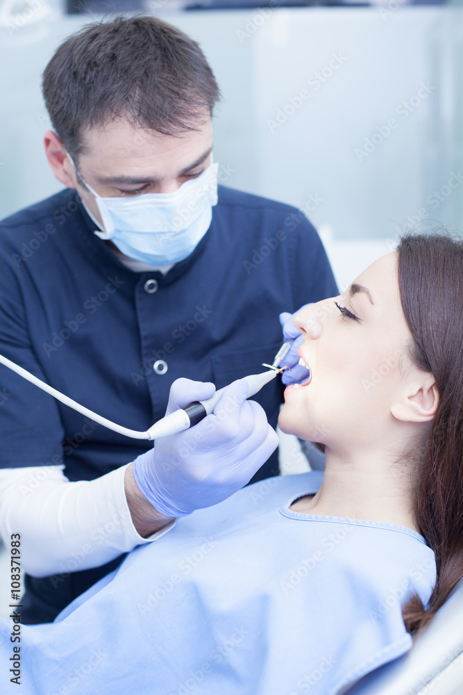 At the dentist. Male dentist in action At the dentist. Male dentist in action