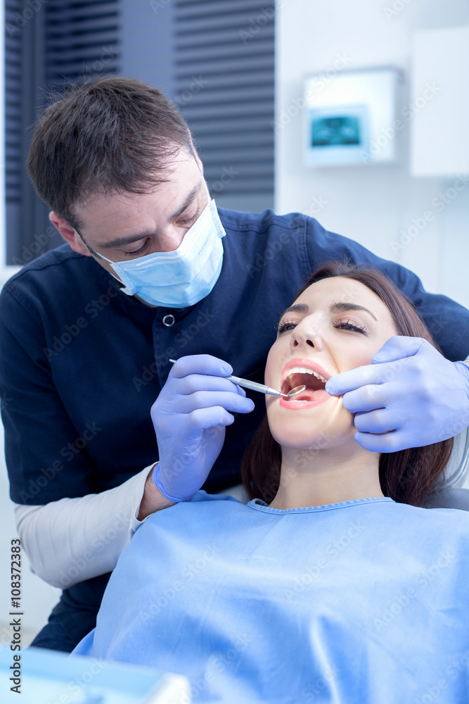 At the dentist. Male dentist in action At the dentist. Male dentist in action