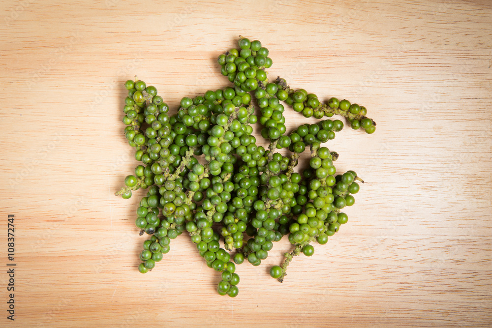 pile of fresh green pepper on a wooden background pile of fresh green pepper on a wooden background