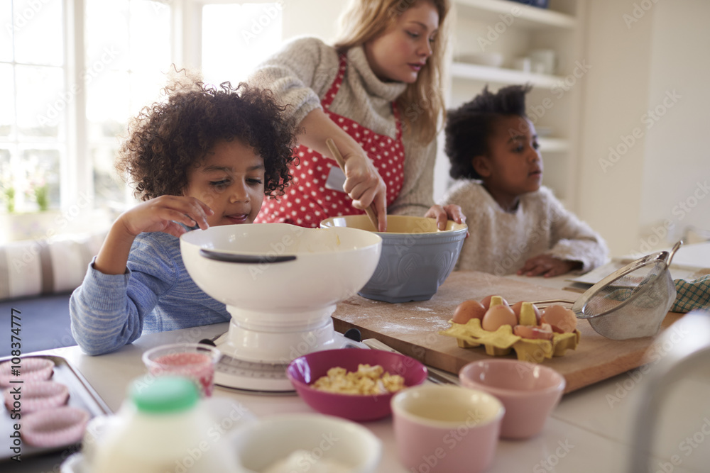 Mother Baking Cake With Children In Kitchen At Home Mother Baking Cake With Children In Kitchen At Home