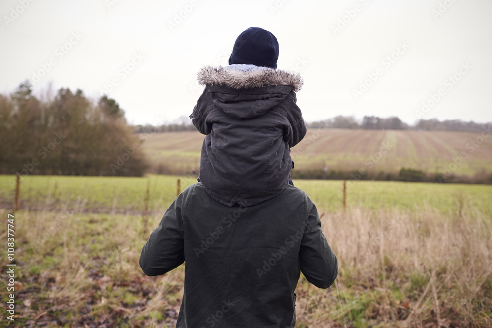 Father Gives Son Ride On Shoulders During Countryside Walk Father Gives Son Ride On Shoulders During Countryside Walk