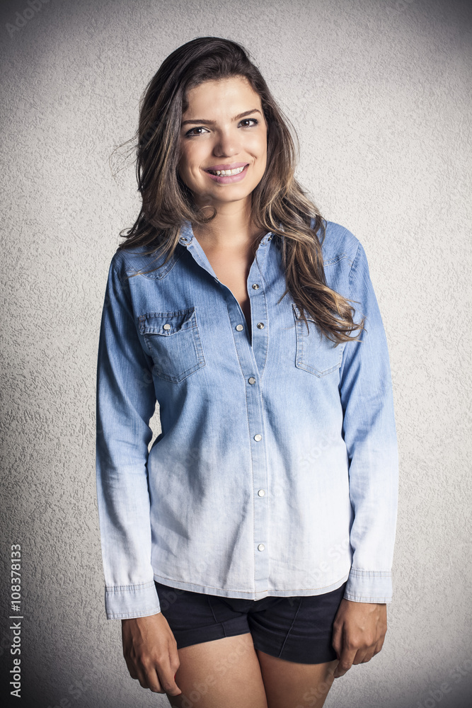 Attractive girl model posing in a jeans shirt Attractive girl model posing in a jeans shirt