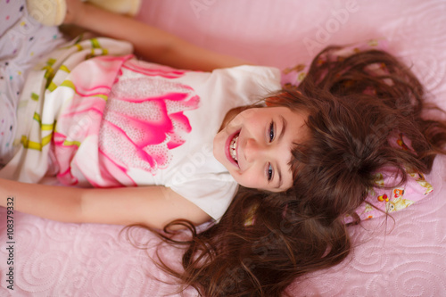 beautiful little girl laughing. The child has long hair
