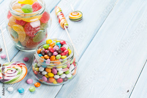 Colorful candies on wooden table © karandaev