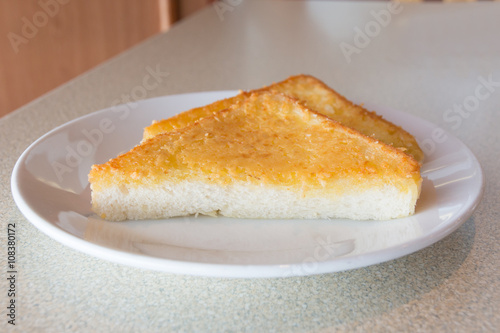 Fried triangle bread with cheese and butter
