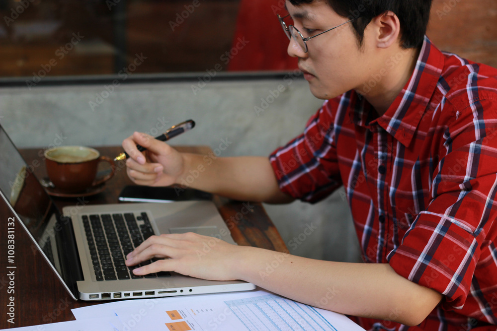 Man typing with laptop at coffee shop Man typing with laptop at coffee shop