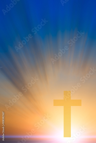 Cross of hope and faith in God and in the background rays of sun