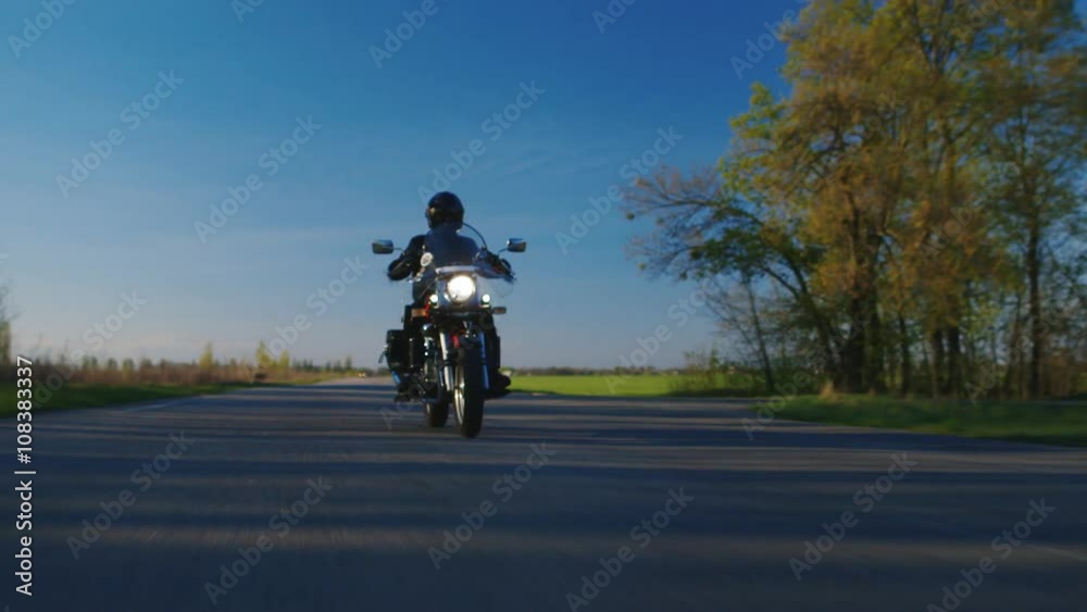 Biker on the road - the extreme lower point shooting Biker on the road - the extreme lower point shooting