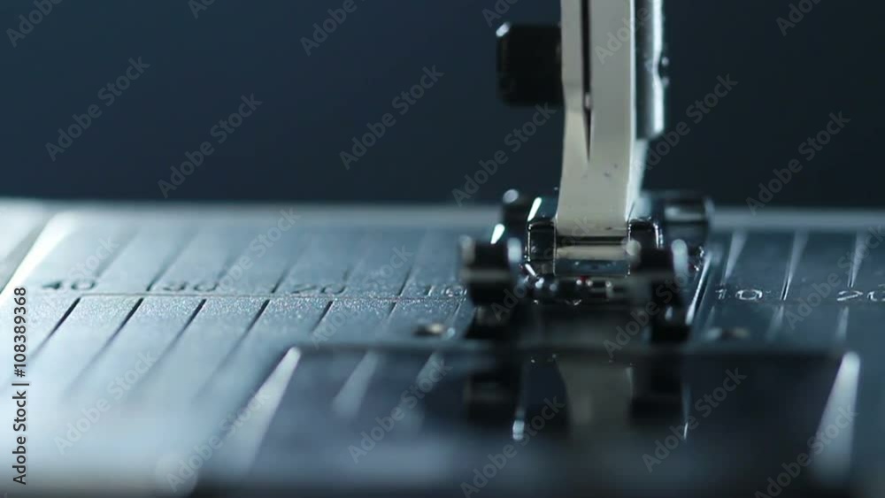 Manufacturing equipment at textile factory. Closeup. Sewing needle in