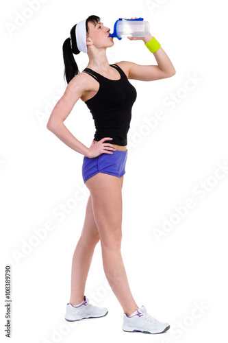 Aerobics fitness woman drinking water isolated in full body.