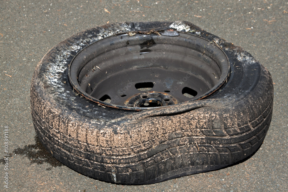 Dirty Deflated Tire on Rim Due to Blowout foto de Stock Adobe Stock