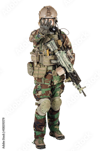 soldier or private military contractor making stop sign with sub machine gun and gas mask. war, army, weapon, technology and people concept. Image on a white background