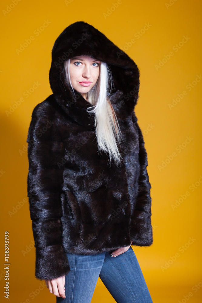 girl in a fur coat poses in a Photo Studio girl in a fur coat poses in a Photo Studio