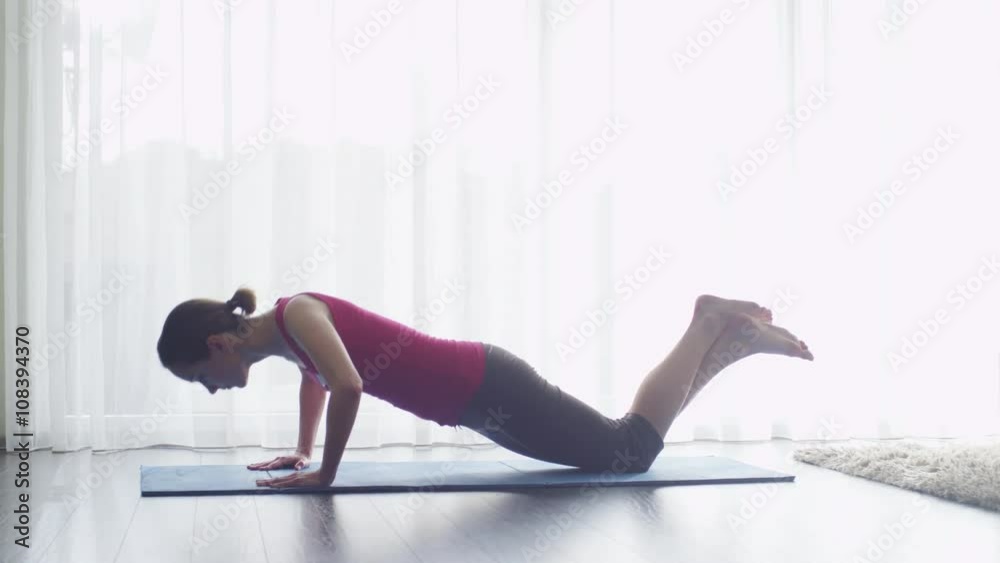Young Woman doing Fitness in Living Room at Home. Shot on RED Cinema Camera. Young Woman doing Fitness in Living Room at Home. Shot on RED Cinema Camera.