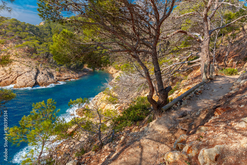 The hiking trail over Cala Pola bay, on coast of the Balearic Sea near Tossa de Mar, in the summer morning, Costa Brava, Catalunya, Spain