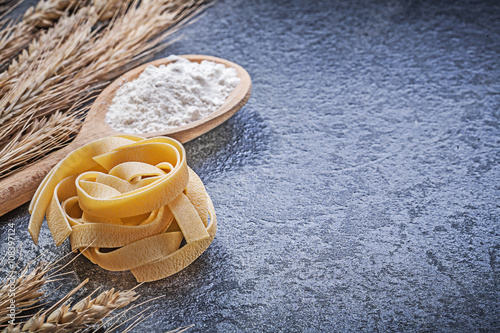 Golden wheat rye ears wooden spoon flour long-cut twisted macaro photo