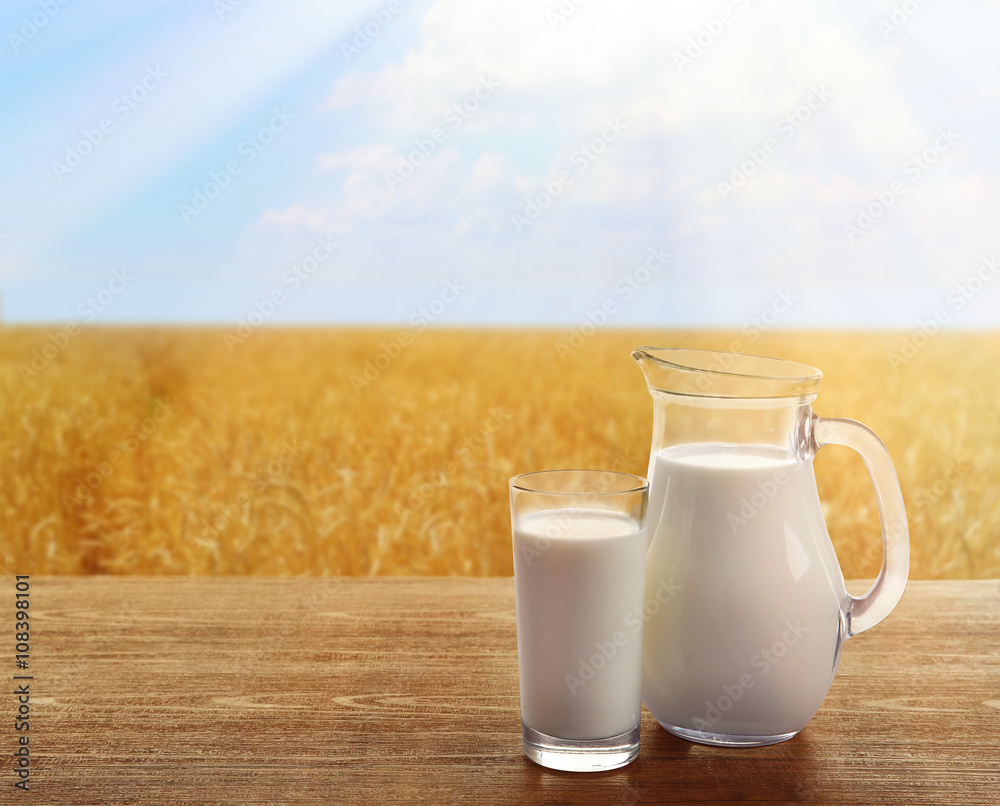 Milk in glassware on sunny nature background Milk in glassware on sunny nature background