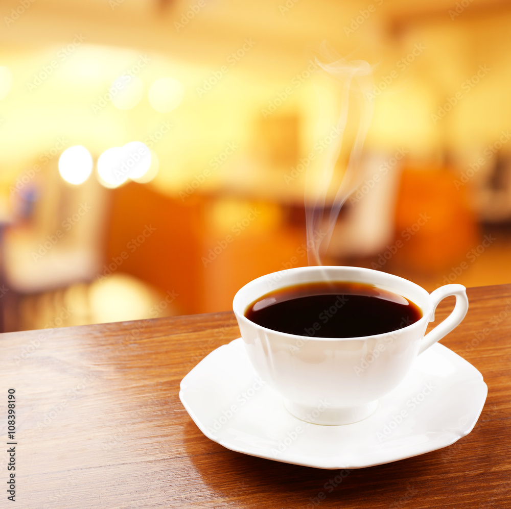 Cup of coffee on table on blured cafe background Cup of coffee on table on blured cafe background