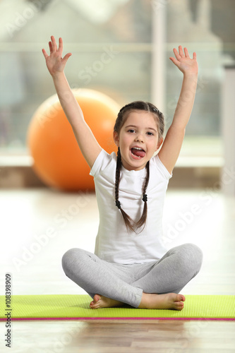 Little funny girl sitting w...