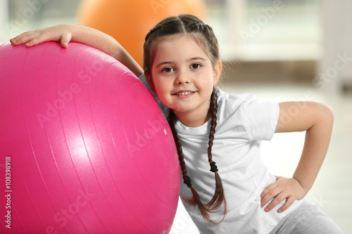 Little cute girl with exerc...