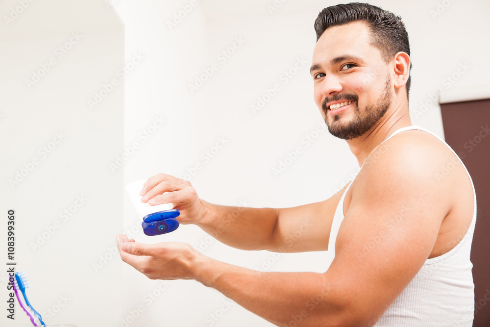 Hispanic man using some cream for his skin Hispanic man using some cream for his skin
