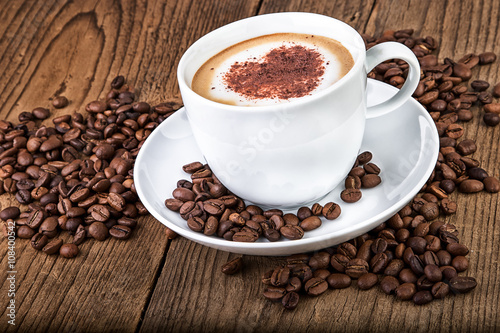 Coffee cup cappuccino on dark wooden background.