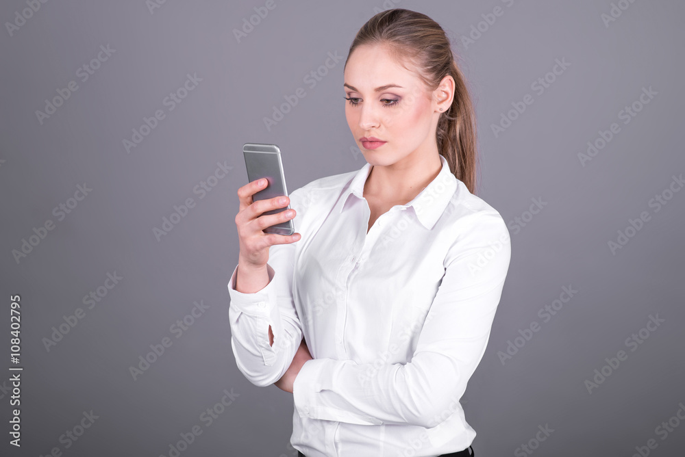 Business woman looking at mobile phone Business woman looking at mobile phone