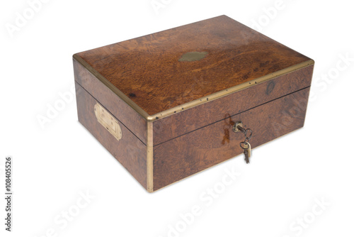 A Closed Vintage Wooden Grooming Box with Key in Lock