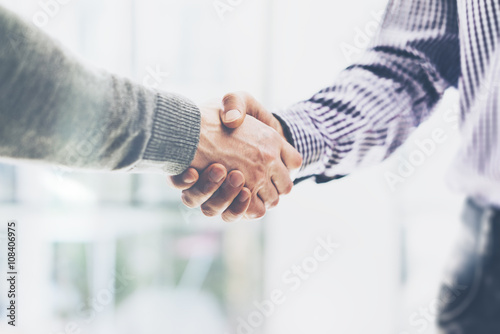 Business partnership meeting concept. Image businessmans handshake. Successful businessmen handshaking after good deal. Horizontal, blurred background