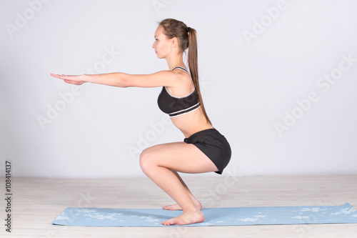 young girl engaged in yoga exercising and stretching