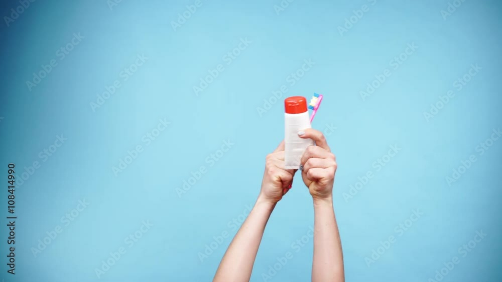 Woman hands holds toothbrush and paste for teeth cleaning 4K