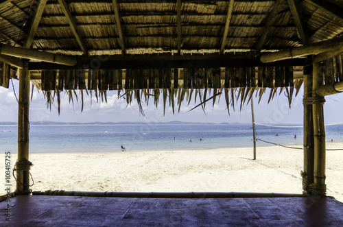 Fototapeta Naklejka Na Ścianę i Meble -  beautiful tropical beach with white sandy beach from bamboo hut. beach volley ball net on background.