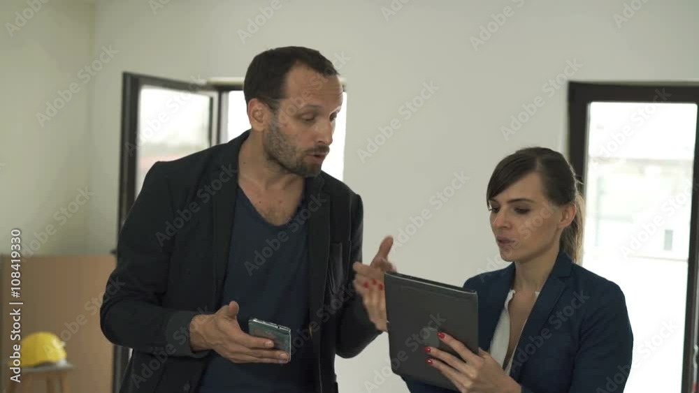 Young couple with smartphone and tablet fighting about new home project
Young couple with smartphone and tablet fighting about new home project