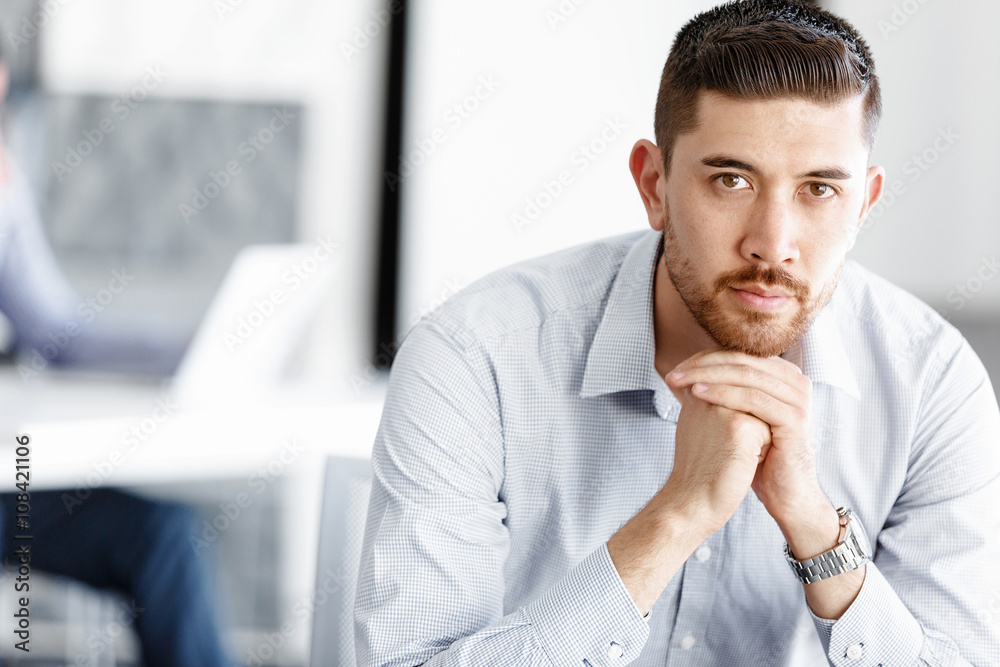 Attractive office worker sitting at desk Attractive office worker sitting at desk