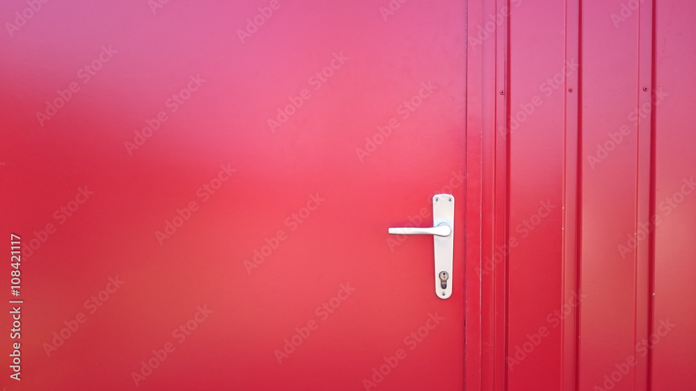 closed red metal door with handle and key hole closed red metal door with handle and key hole