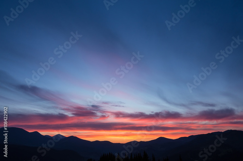 Colorful beautiful sunset over the mountain hills