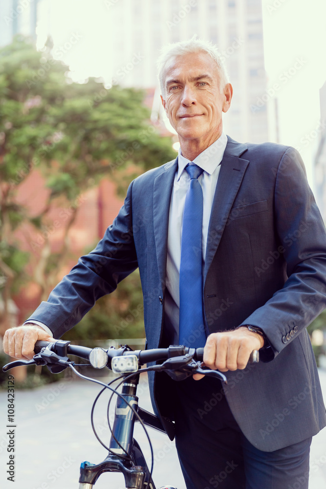 Fototapeta premium Successful businessman riding bicycle