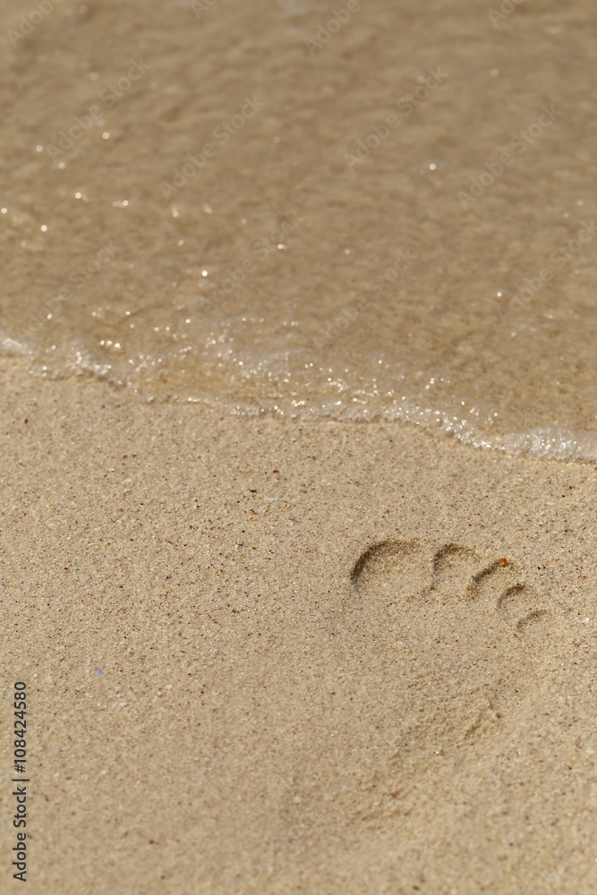 A foot print on sandy beach, selective focus. A foot print on sandy beach, selective focus.