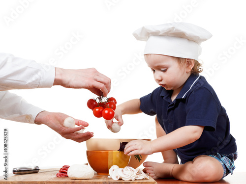 Little boy cook pizza. Clos...