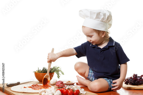 Little boy cook pizza. Clos...