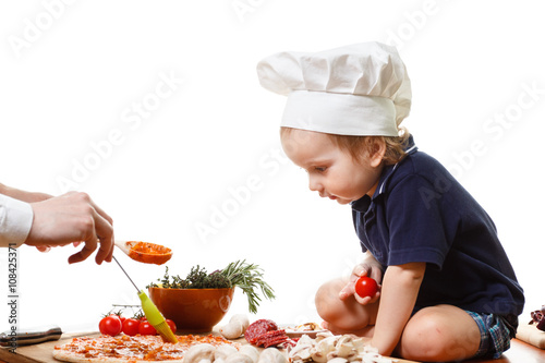 Little boy cook pizza. Clos...
