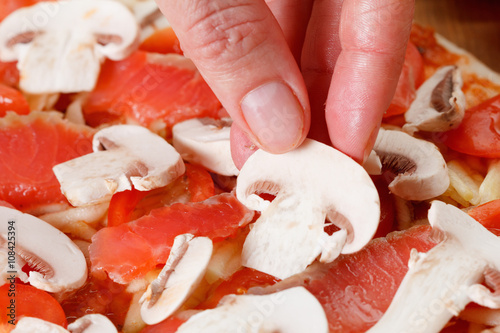 Cooking homemade pizza with...