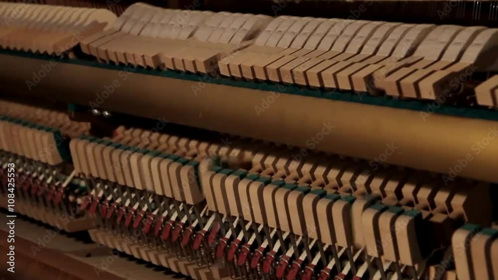 Open piano mechanics while playing, hammers moving and hitting piano strings Open piano mechanics while playing, hammers moving and hitting piano strings