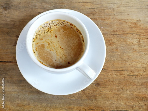 cup of coffee on a wooden table background