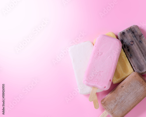 Ice cream stick on pink background with copy-space.